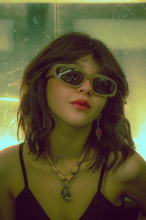 Young Woman is Sunglasses and Pierced Lip