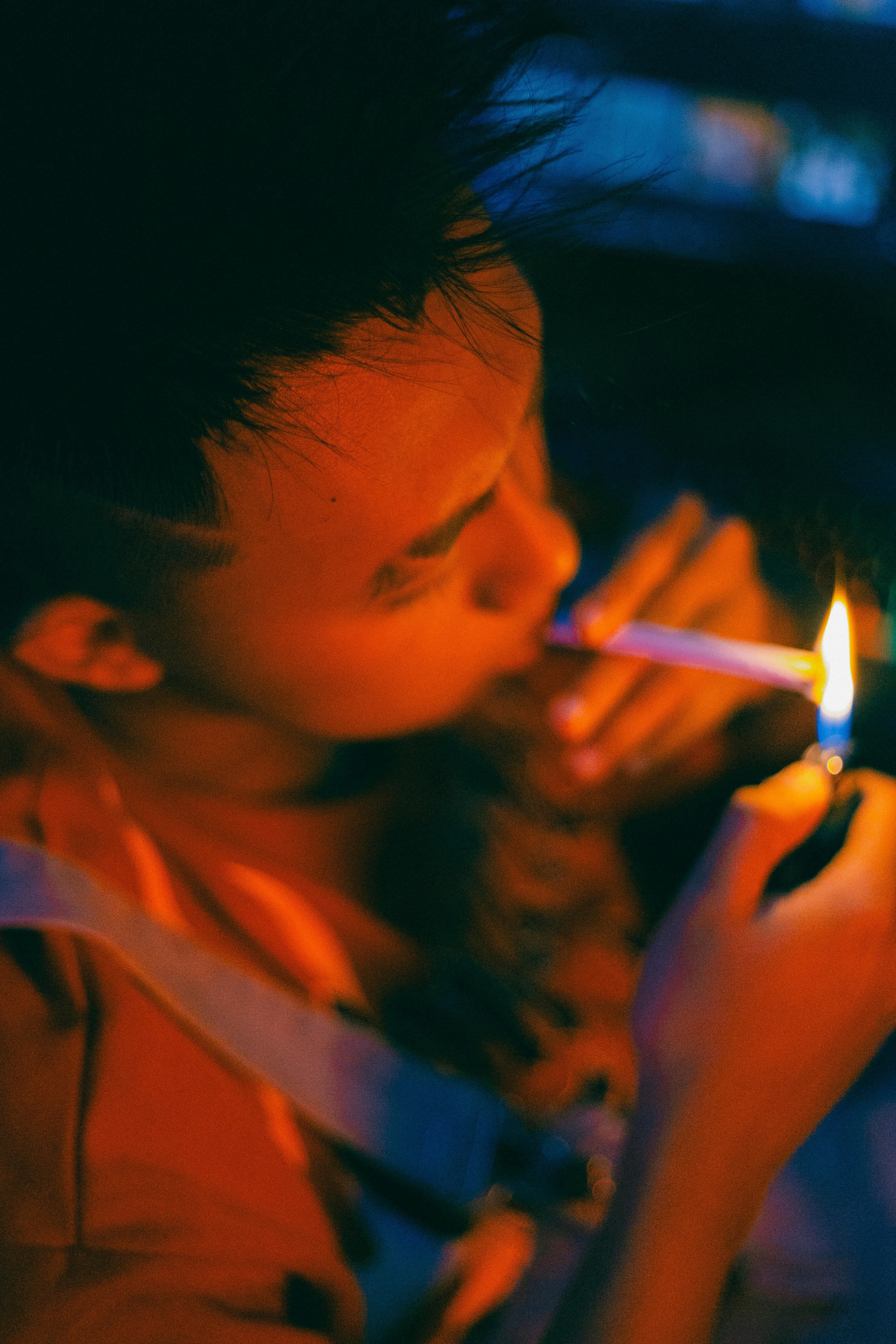 Young Man Lighting a Cigarette · Free Stock Photo