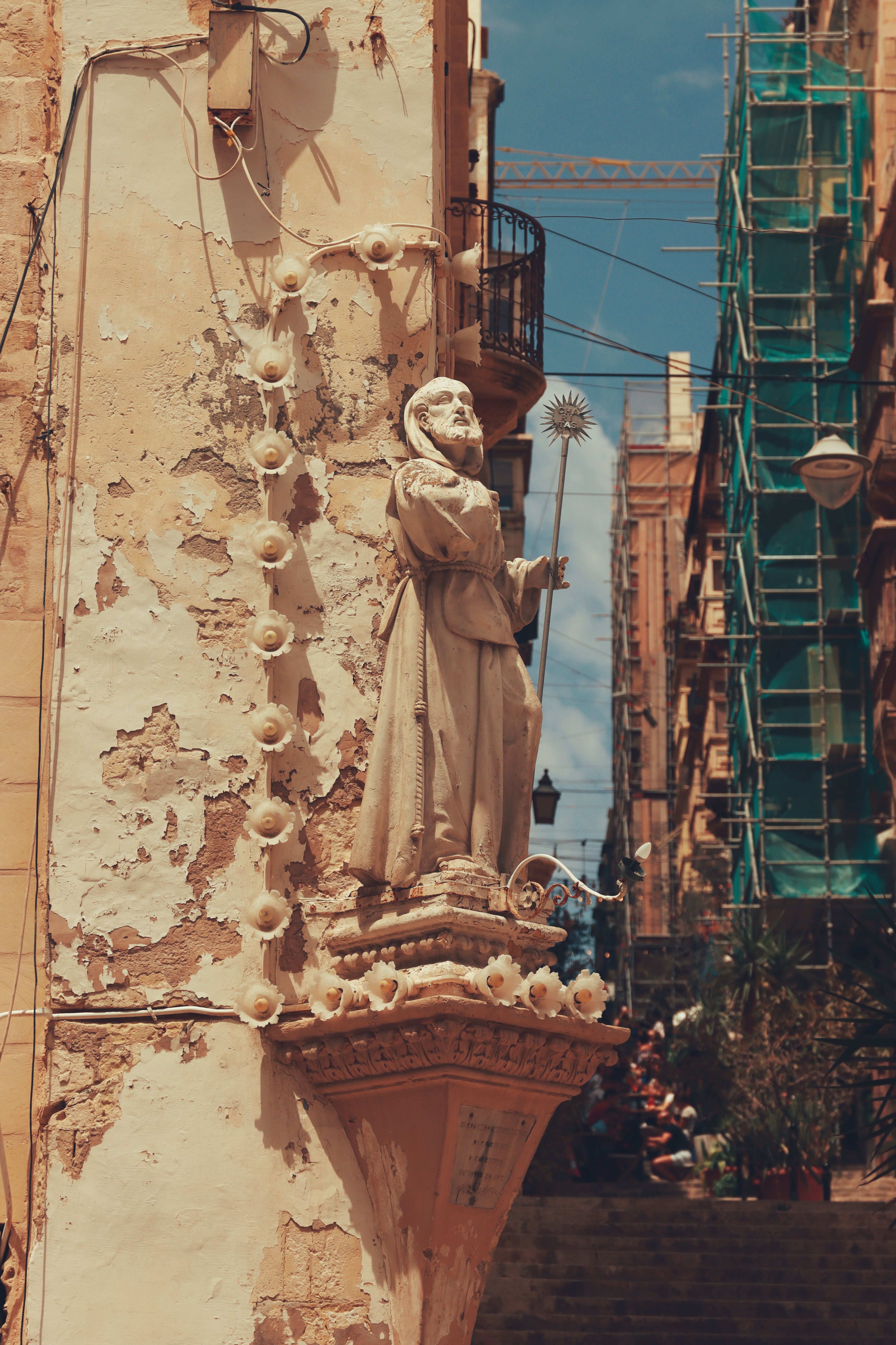 Beautiful stone sculpture depicting a religious figure on a Valletta street corner, Malta.