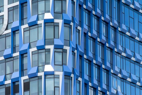 Free Close-up of a modern blue building facade with geometric patterns in Amsterdam. Stock Photo