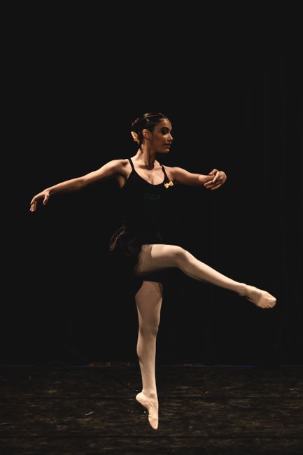 Graceful ballerina in spotlight during a captivating ballet performance.