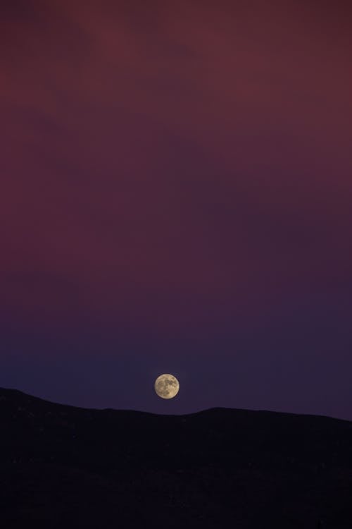 Moon over the Silhouette of a Hill