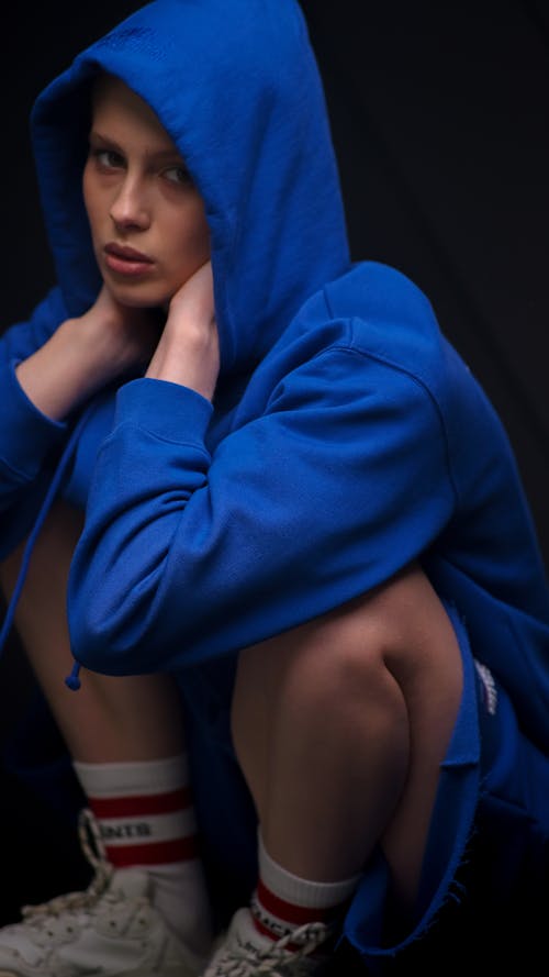 Studio Shot of a Young Woman in a Blue Hoodie 