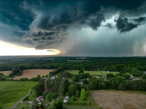 Aerial view of dark storm clouds over countryside in Fallston, NC, showcasing a dramatic weather scene.