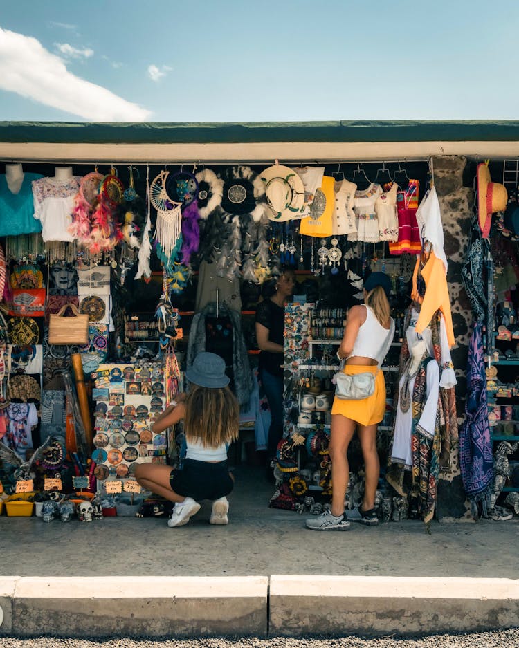 Women At Store With Clothes And Souvenirs