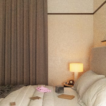 A cozy bedroom featuring a soft-lit lamp, neutral decor, and a comfortable bed with scattered items.