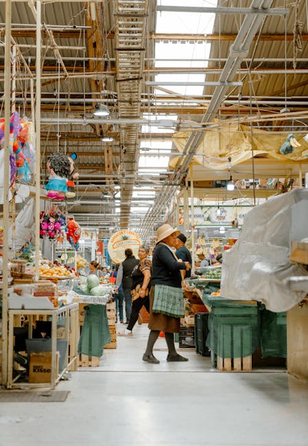 A vibrant food market in Auckland with diverse food stalls and people browsing