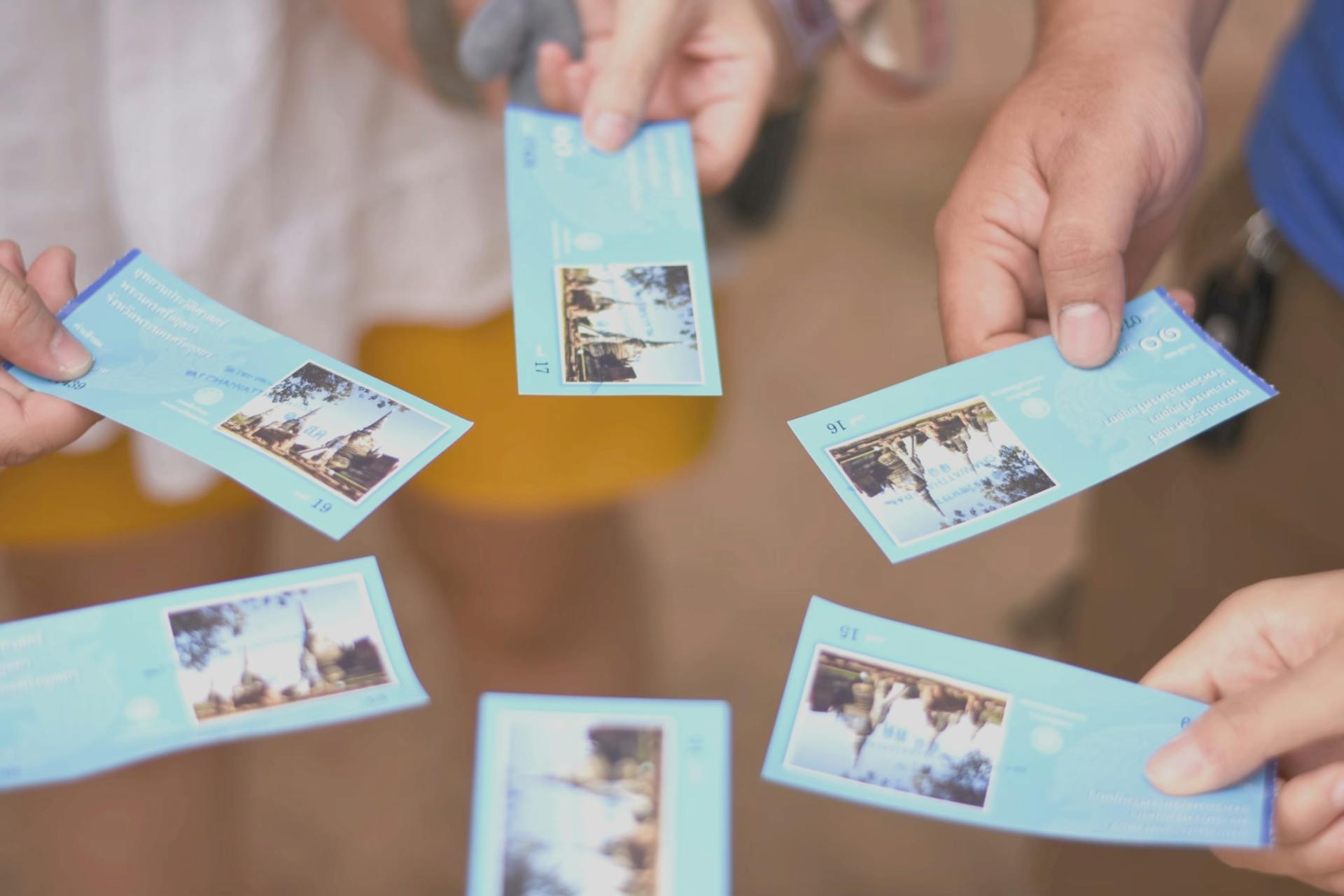 Close-up of a group holding tourist attraction tickets. Perfect for travel and tourism themes.