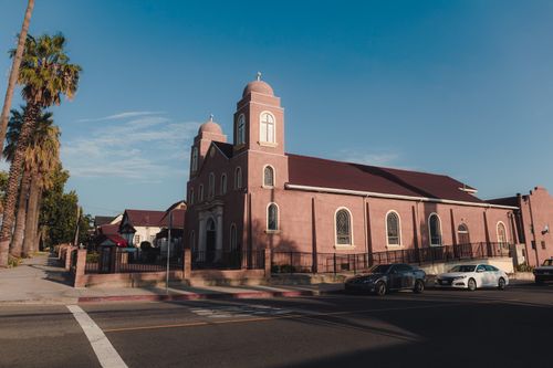 Free A picturesque urban church surrounded by palm trees on a bright, clear day. Stock Photo