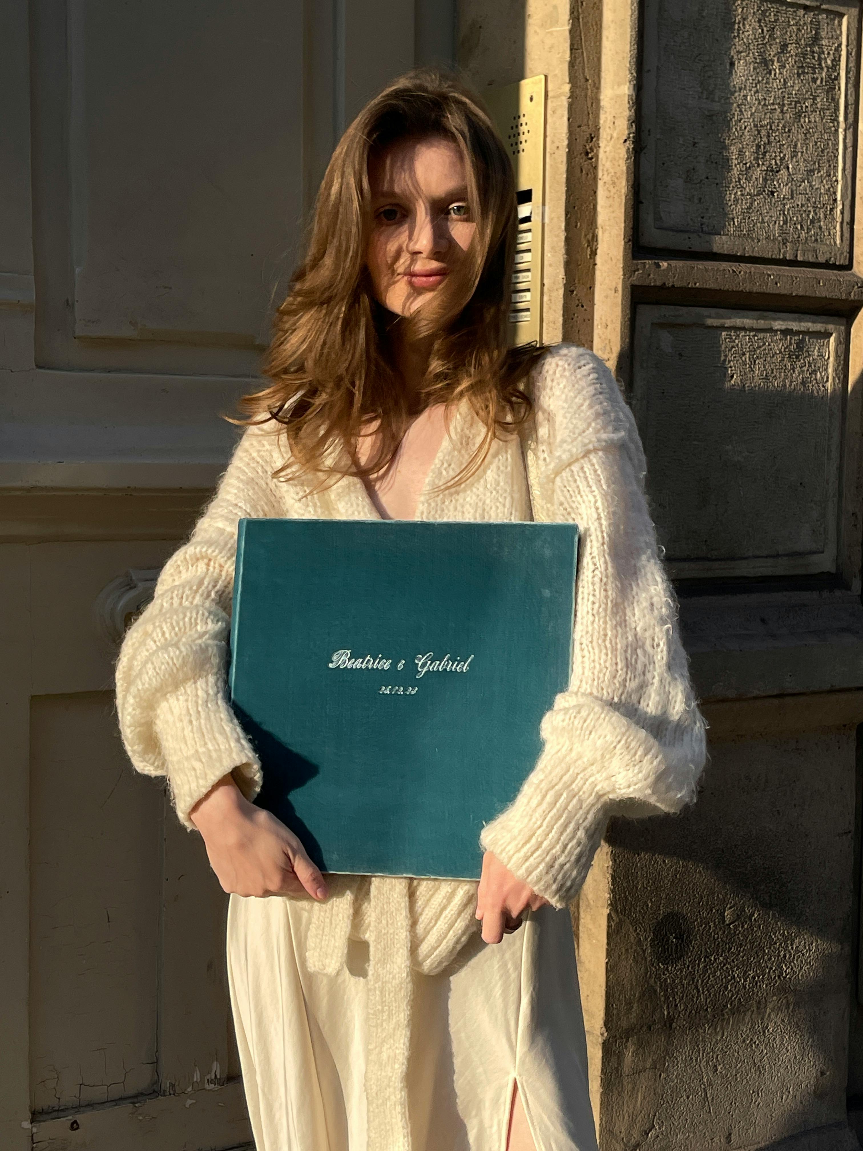 Woman in White Clothes Standing and Posing with Album · Free Stock Photo