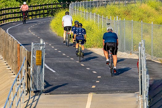 Cyclists enjoying a sunny day ride on a scenic outdoor pathway.