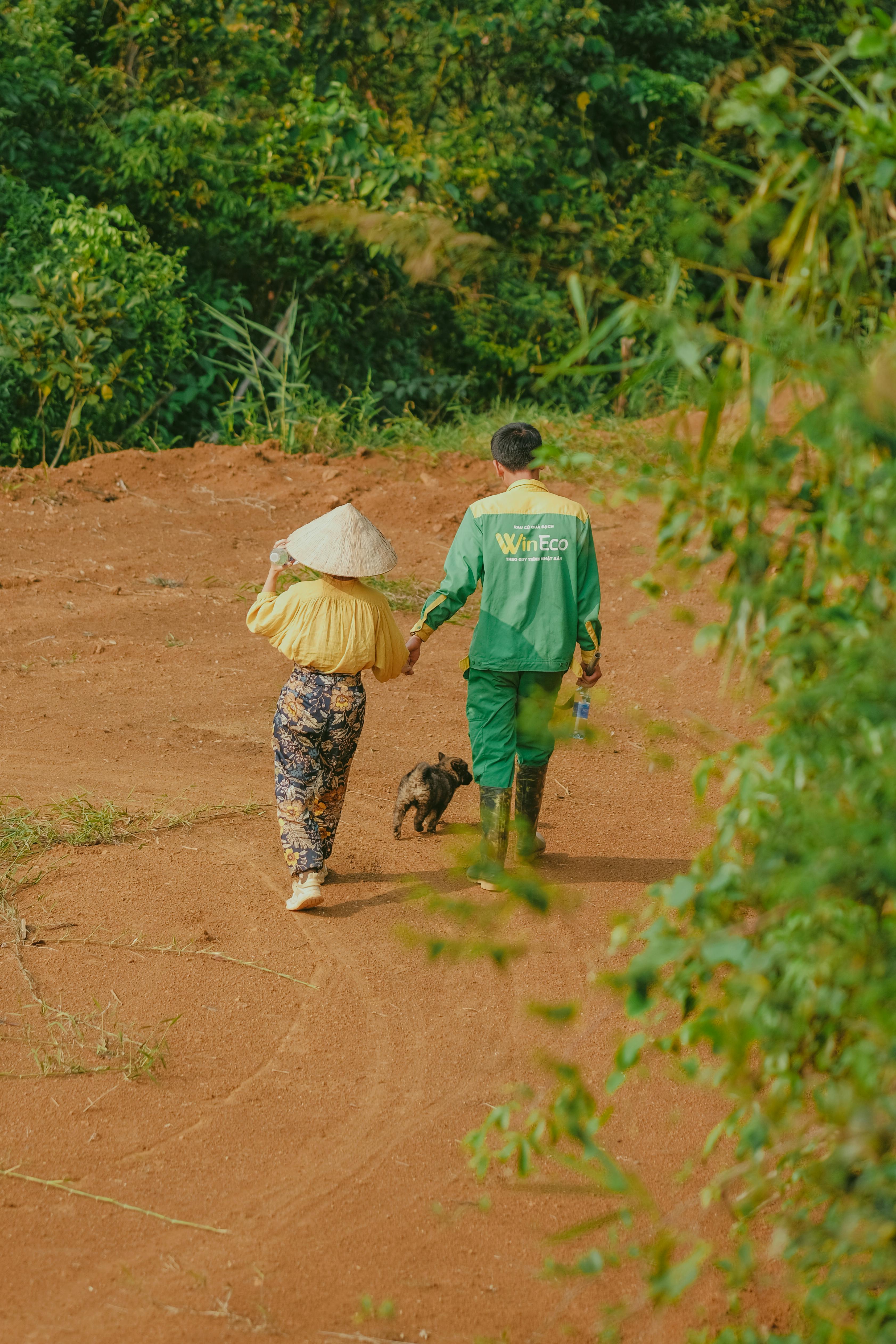 man with kid walking the dog in countryside