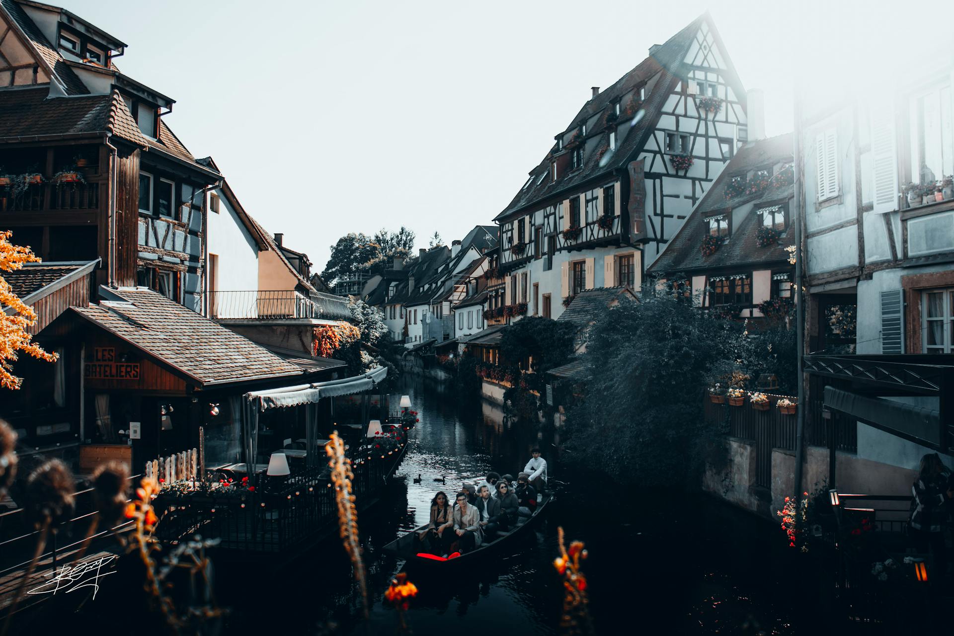 Idyllic view of Colmar's canals with half-timbered houses and a boat ride.