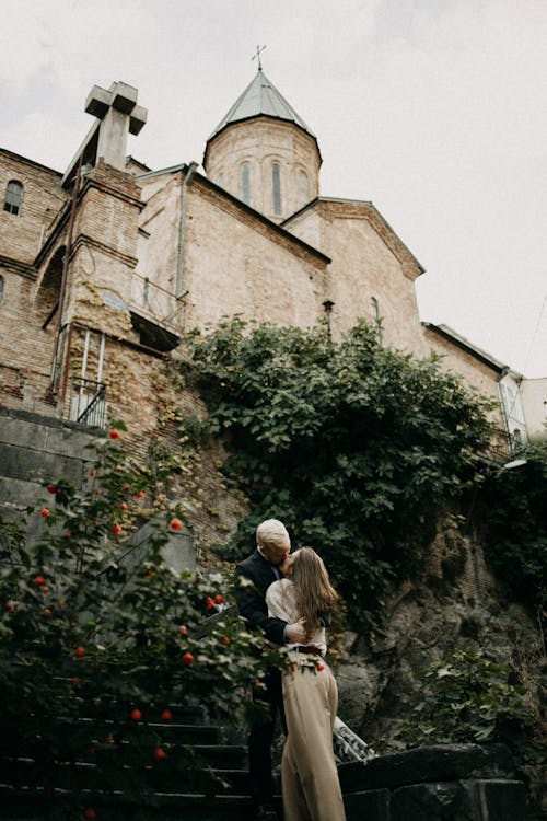 A Couple Kissing in front of a Castle 