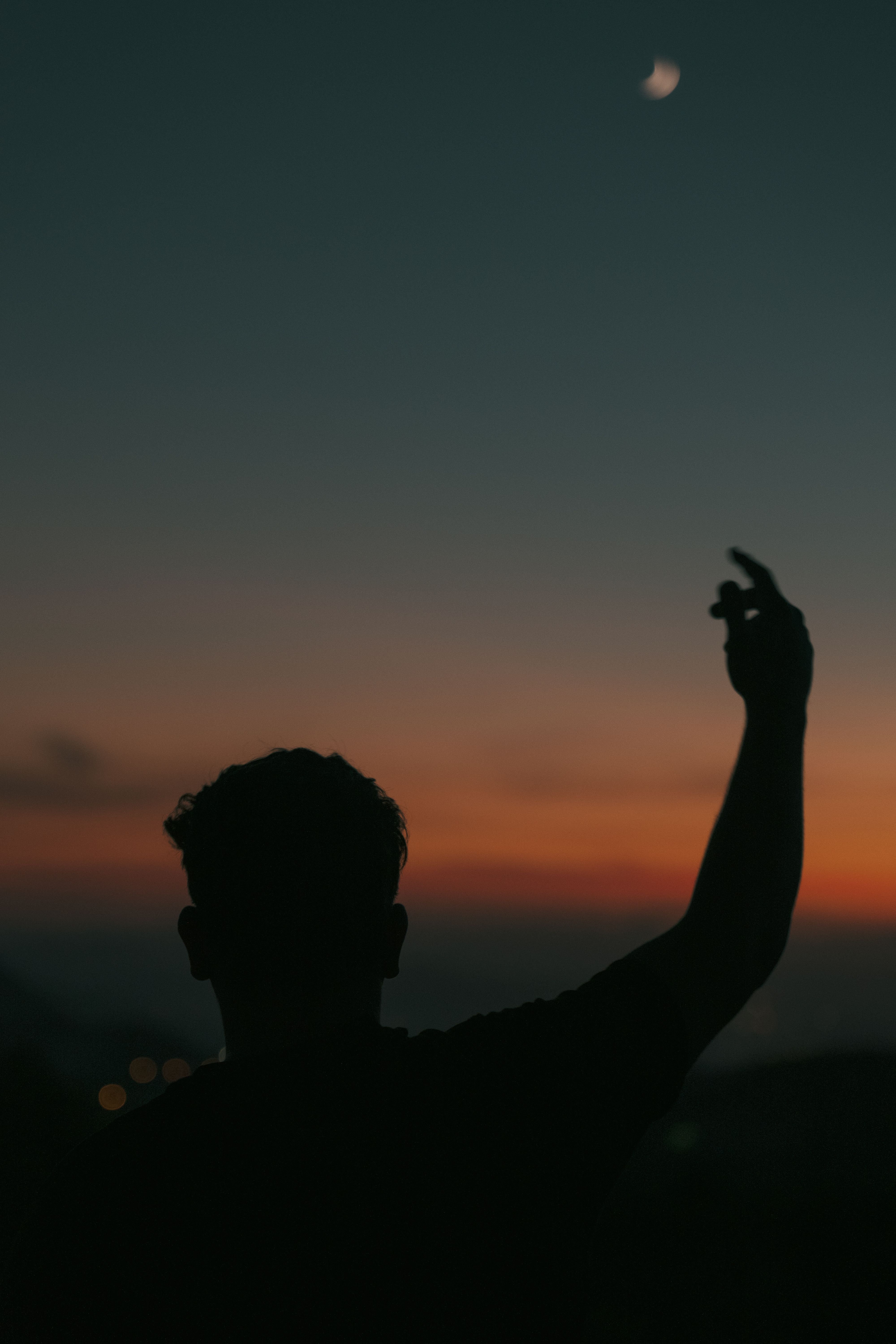 Silhouette of a Woman Raising Her Arms · Free Stock Photo