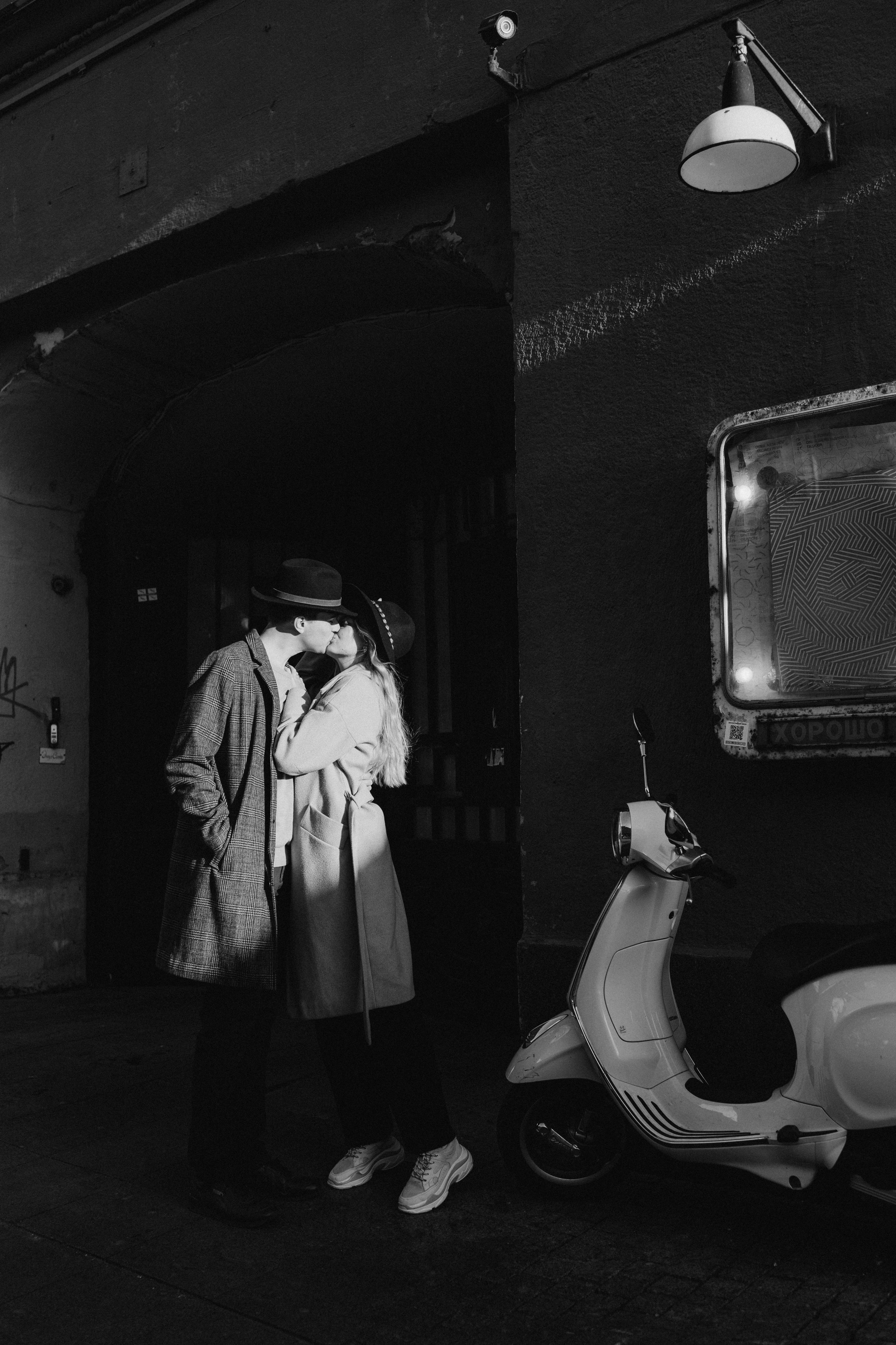 Black and White Picture of a Couple Kissing on a Sidewalk · Free Stock Photo