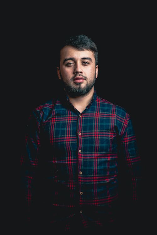 Studio Shot of a Bearded Man in a Checkered Shirt 
