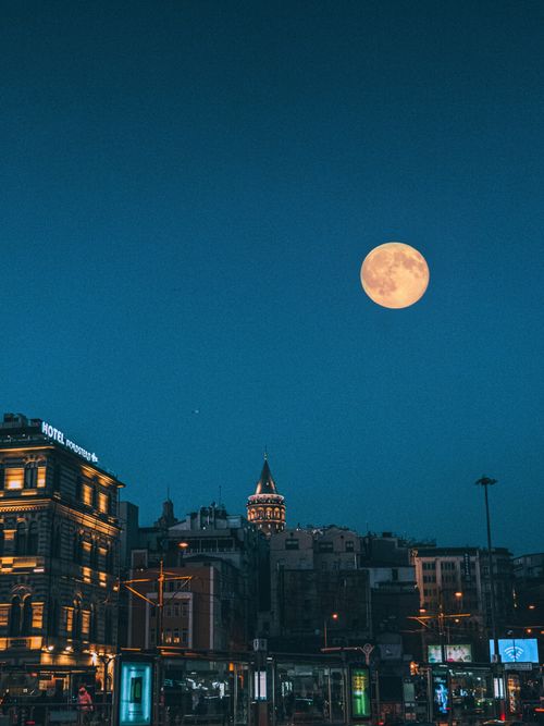 Free Captivating night cityscape with full moon above Galata Tower in Istanbul, Turkey. Stock Photo