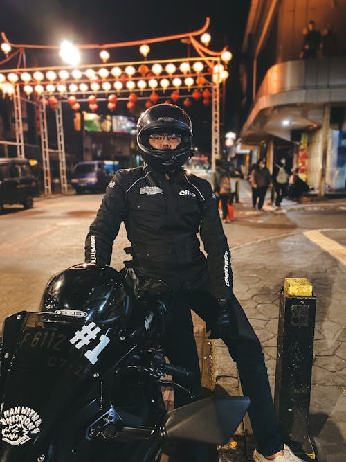 Man with Motorbike in Town at Night
