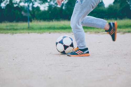 Free Person in White Pants and Black and White Nike Soccer Ball Stock Photo