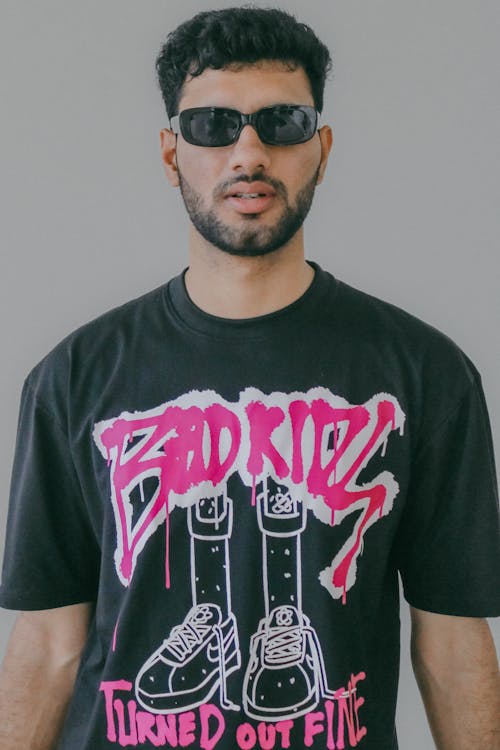 Young Man Wearing a Graphic T-shirt and Sunglasses 