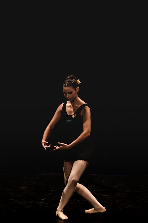 Ballerina Dancing on Black Background