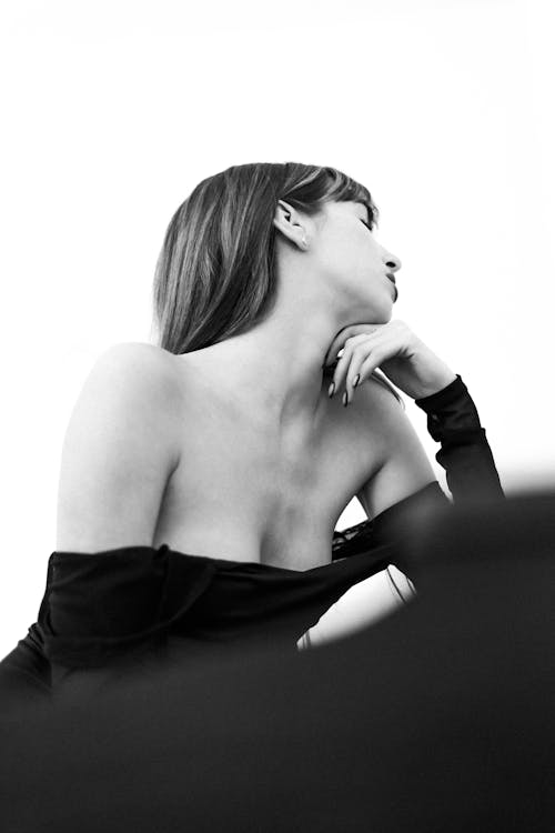 Woman Sitting in Dress in Black and White