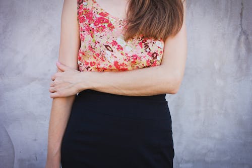 Woman Wearing Red and Green Sleeveless Shirt and Black Bottoms