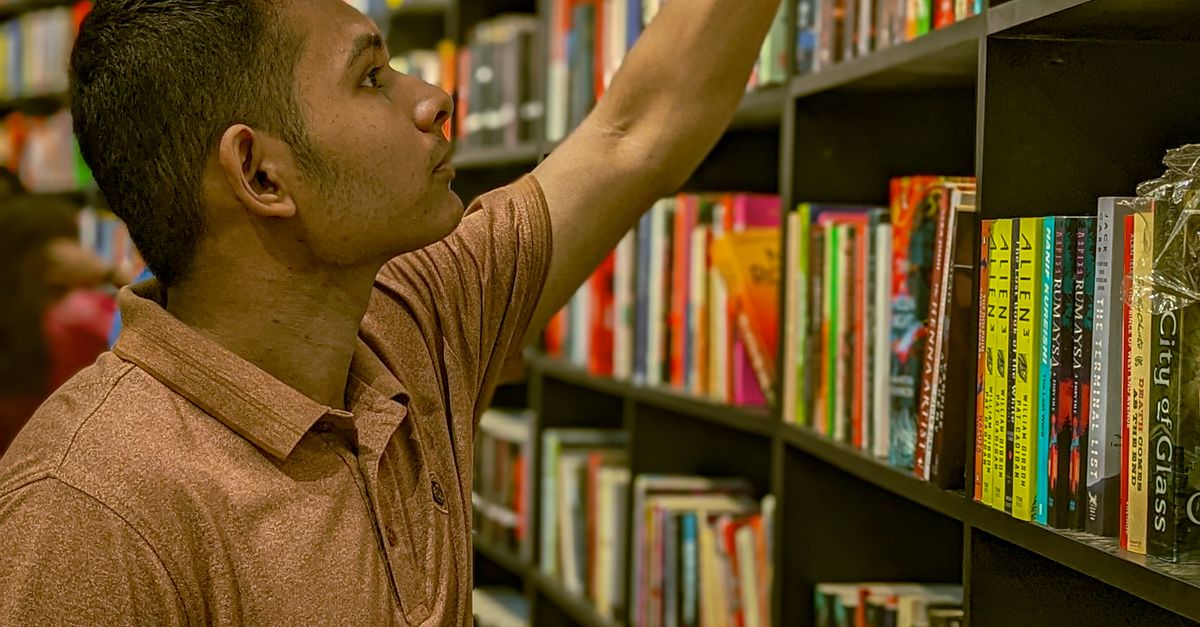 Library Core Man A Young Man in a Library · Free Stock Photo
