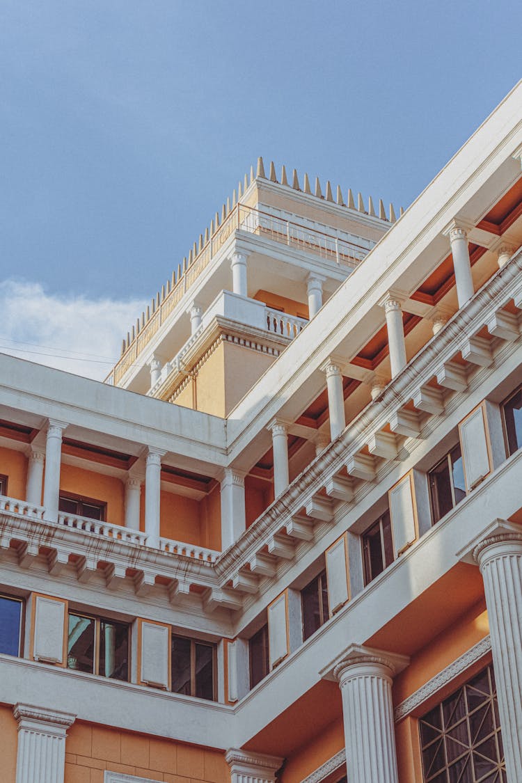 Clear Sky Over Ornamented Building Walls