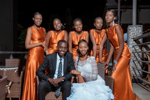 Newlyweds Posing with Wedding Guests in Dresses