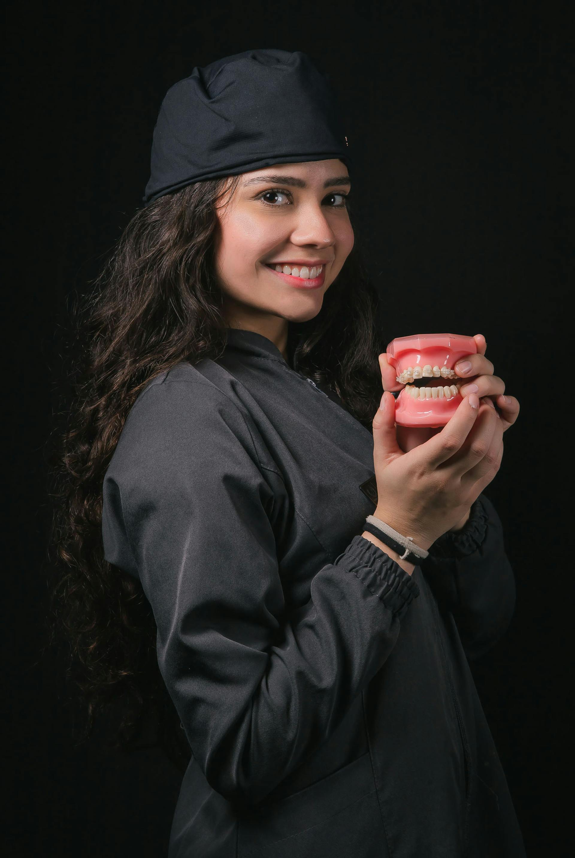 a young woman presenting a denture