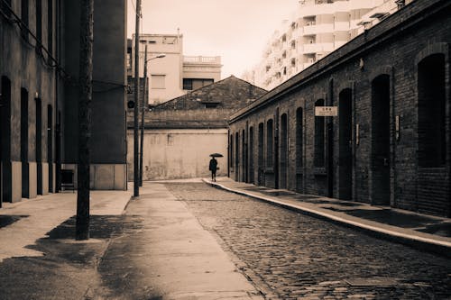 Empty, Cobblestone Street with Person Walking behind