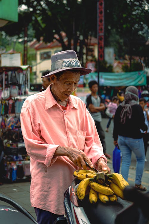 Man in Pink Shirt on Street Market