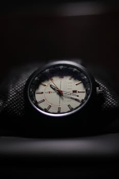 Detailed close-up of a stylish and luxurious wristwatch face with dark background.