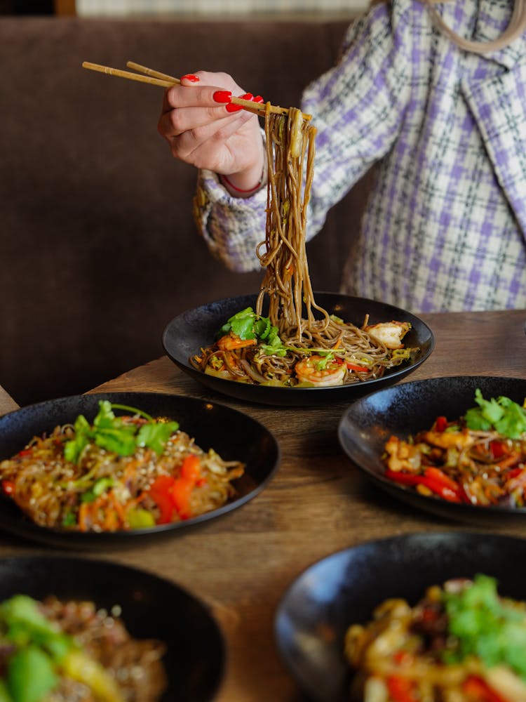 Woman Eating Noodles With Chopsticks