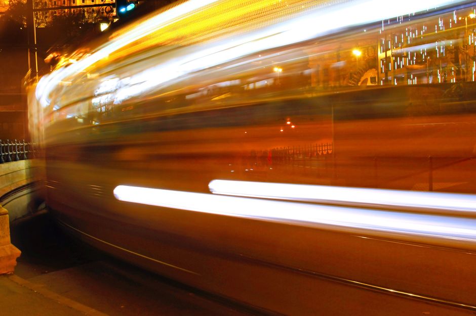 Stunning long exposure capturing blurred motion of a city street at night, creating vibrant light trails.