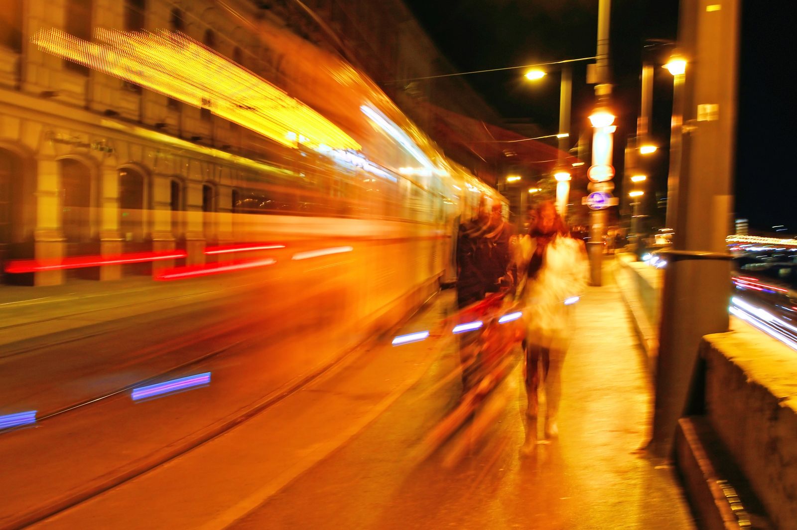 Long-exposure motion trails on a street at night — photo by Adonyi Gábor on Pexels