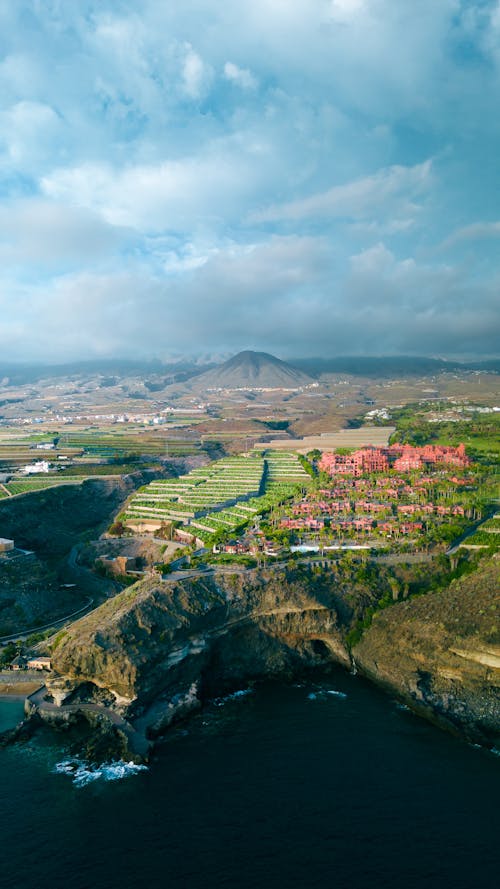 Landscape of a Coastline, Village and a Mountain in a Distance