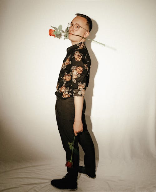 Man in Eyeglasses Holding Rose in Mouth