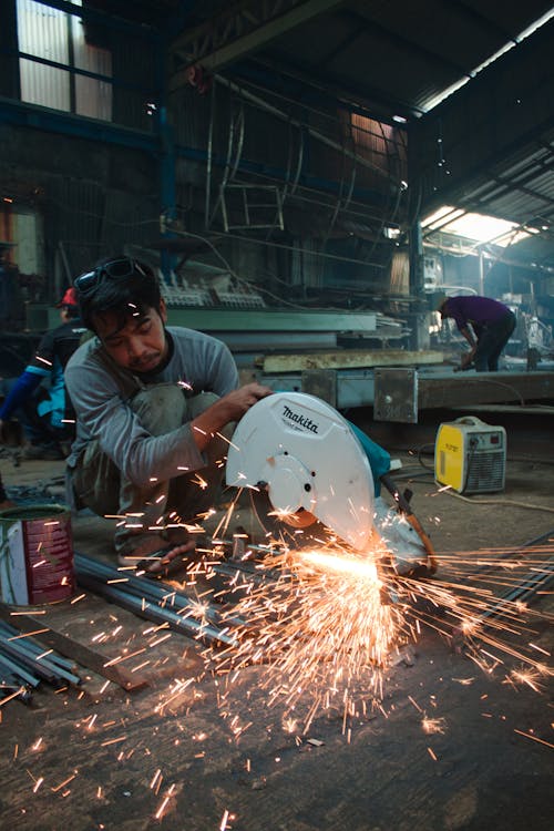 A Man Doing Metalwork in a Workshop 
