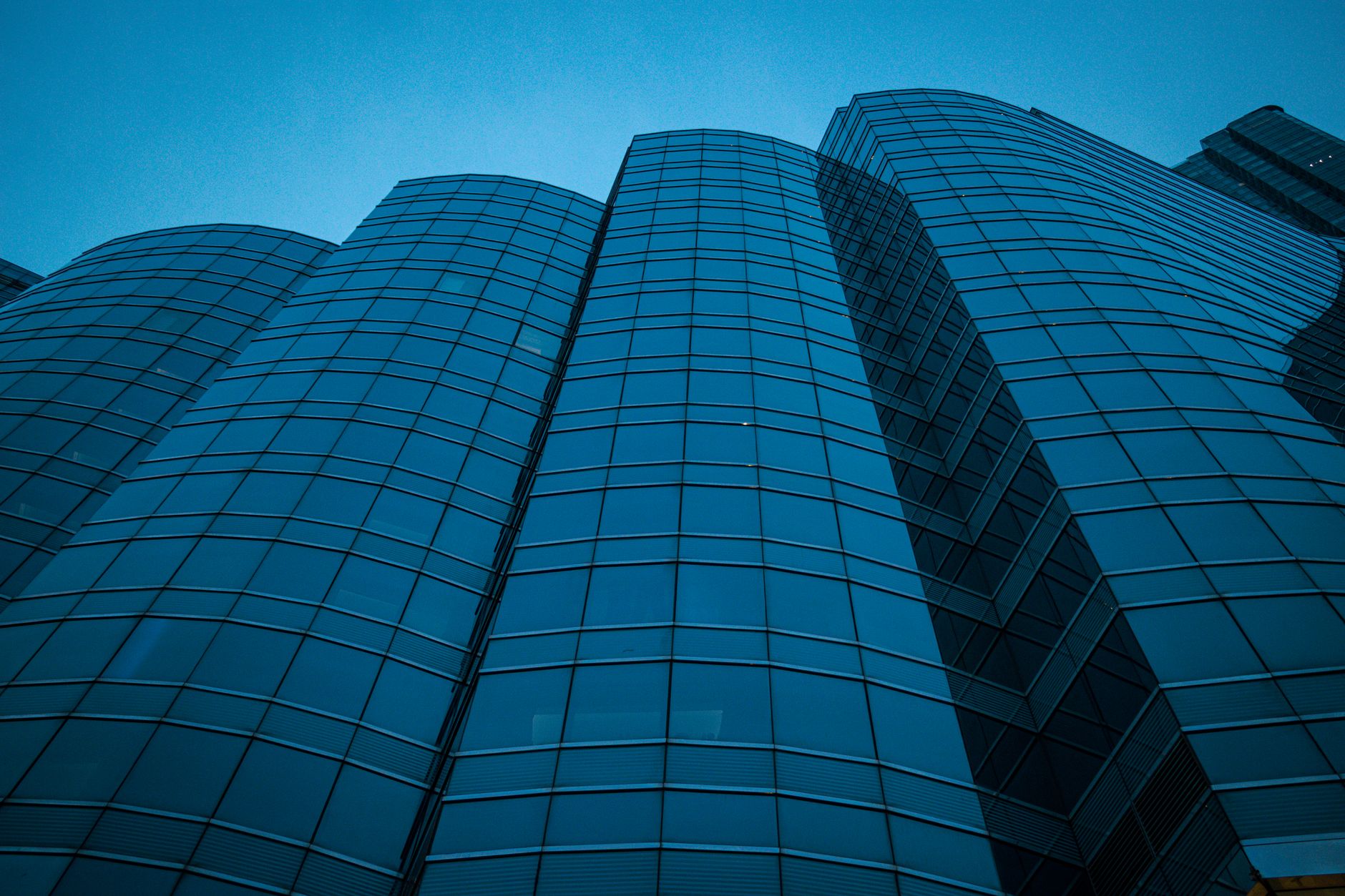 modern glass office tower at dusk