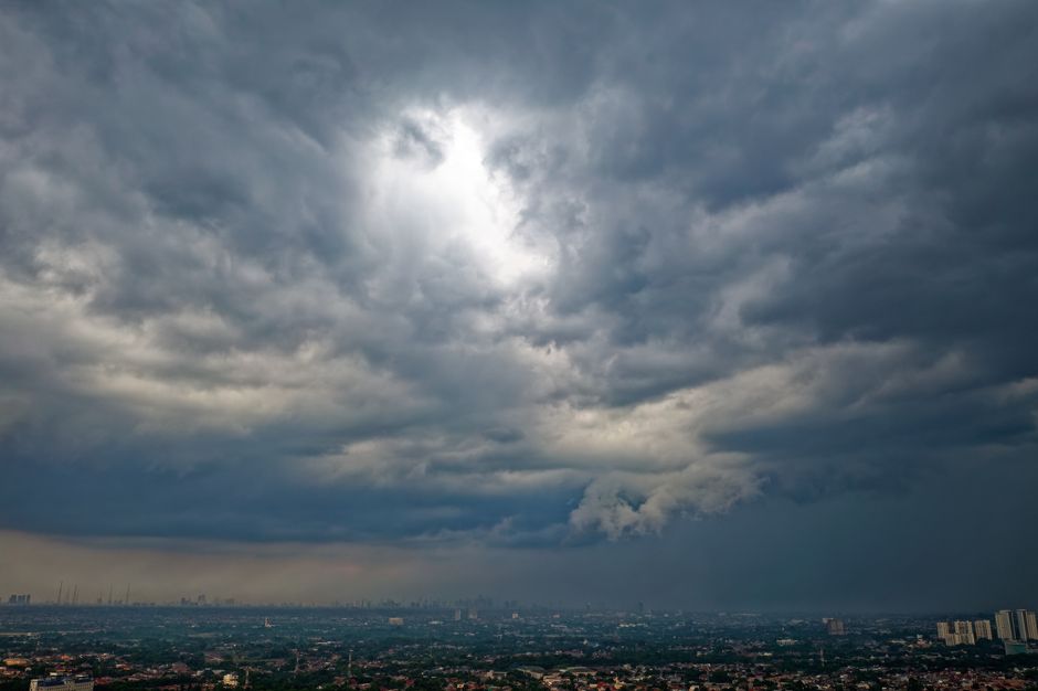 A striking image of an overcast sky with sunbeams breaking through over Serpong, Indonesia.