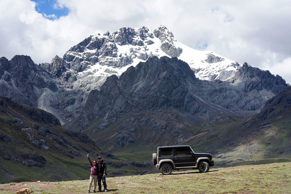 Explore the breathtaking Andes with this adventurous expedition featuring a rugged SUV and stunning snowcapped peaks.