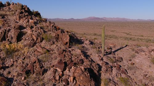 Free Vast desert view with rocky terrain and cacti in Tonopah, Arizona under clear blue skies. Stock Photo