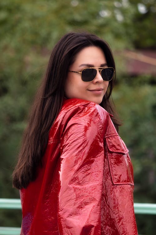 Woman in Sunglasses Posing in Red Jacket