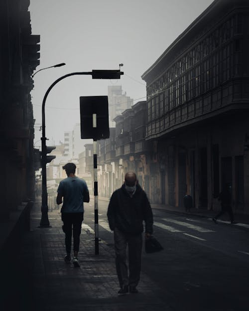 People Walking near Street in Black and White