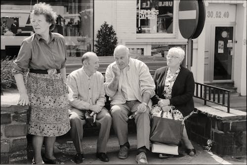 Four Elderly People Talking on a Bench