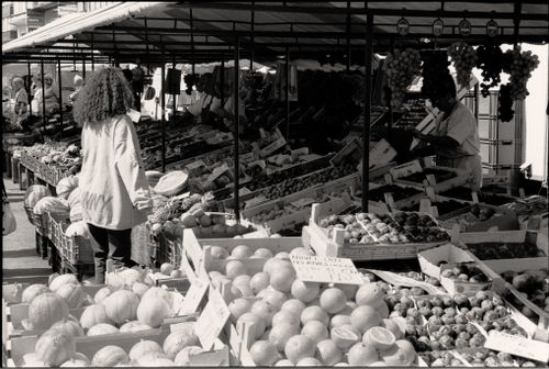 Free A bustling street market with fruits and vegetables. Captured in black and white. Stock Photo