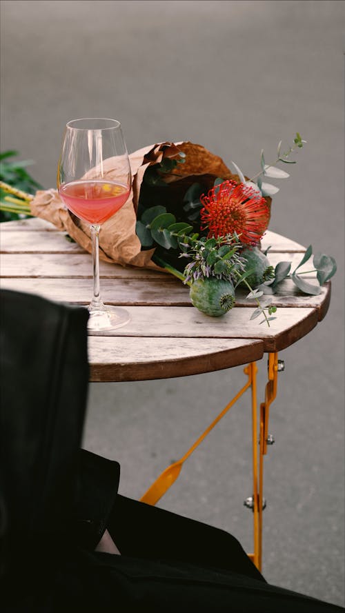 A Cocktail and a Bouquet on the Table 